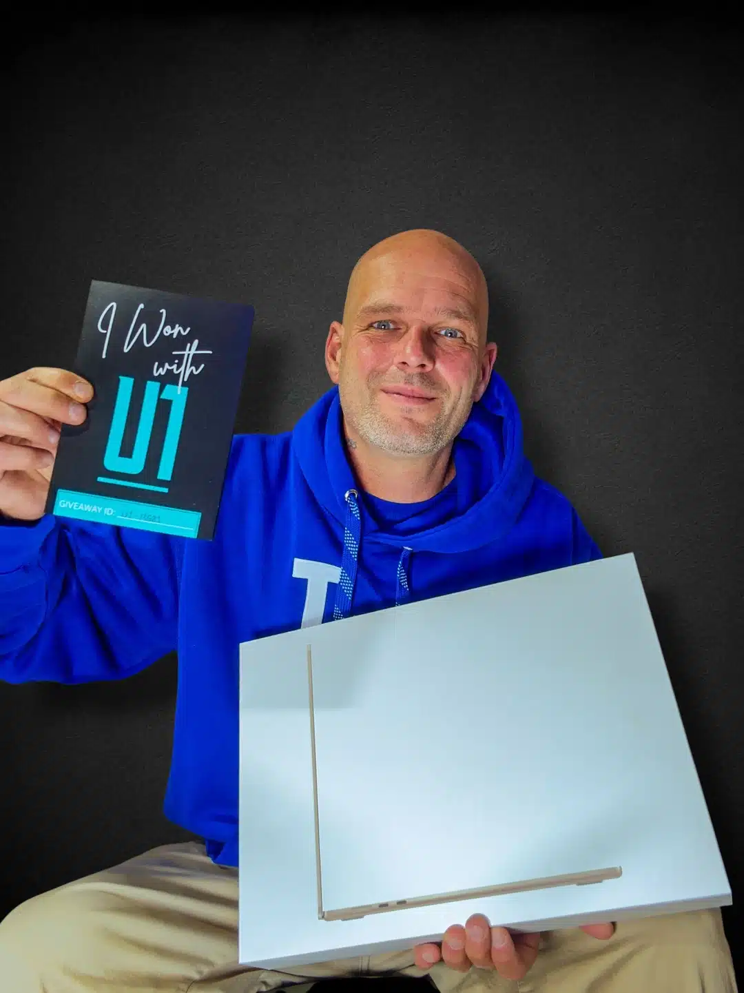 U1-MG01 Winner from Kelowna holding a prize .